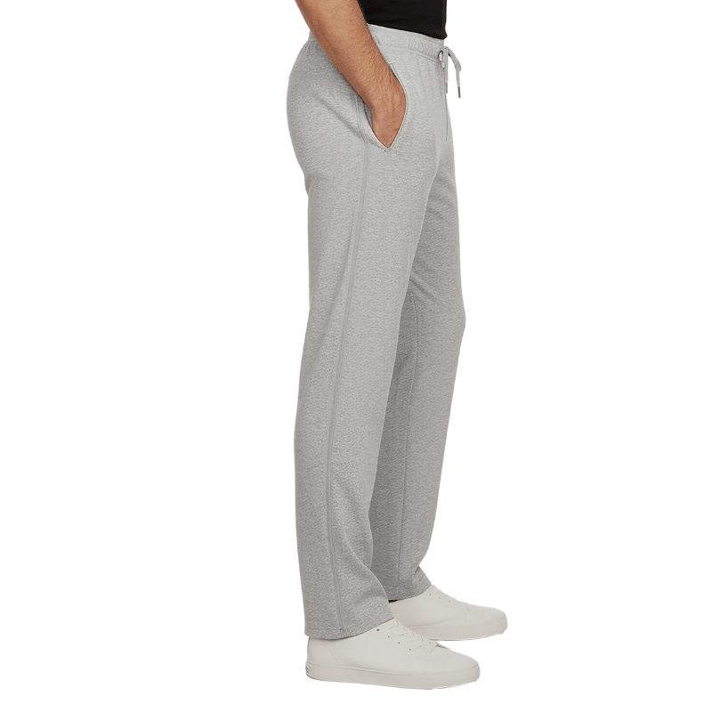 Pantalon de jogging gris avec fermetures éclair latérales fermées et poches, vu de côté sur une personne